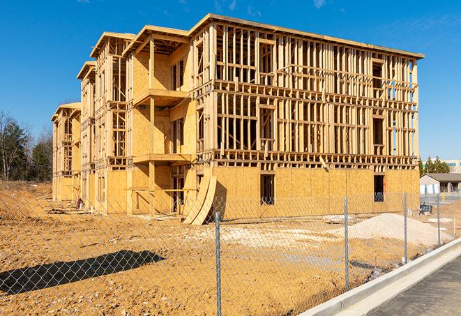 a snapshot of temporary chain link fences protecting a large construction project from unauthorized access in Colton