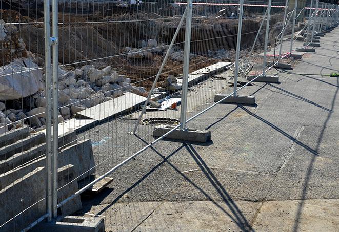 a temporary fence panel being used to secure a construction site at night